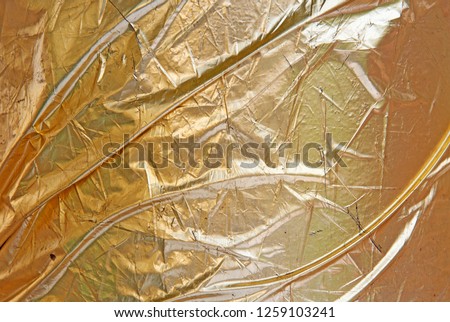 Gold leaf crumpled scratched uncommon texture.