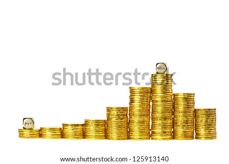 Columns of golden coins rising and down with the dices Buy and Sell isolated on white