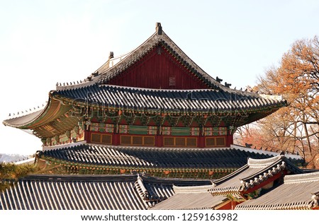 Hipped roofs, tiles, painted decorations, and hermits, monks and monsters on the roof as guardians, typical Korean palatial architecture at Changdeokgung palace, Seoul. Korea