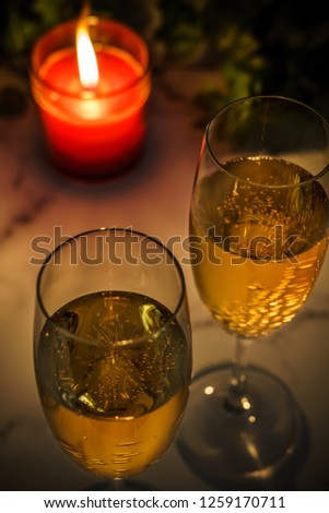 Glasses of champagne with candle