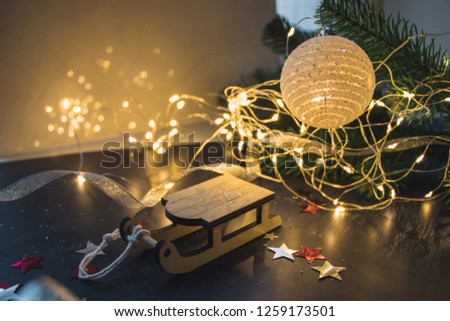 Christmas decorations, fur-tree branches, colorful balls, garlands, red and white glittering stars on a dark background object group