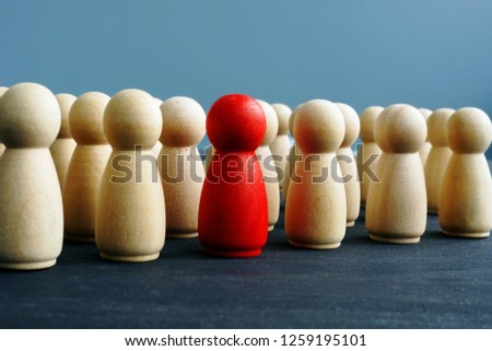 Difference, dissimilarity and distinctness concept. Wooden figures on a desk. Royalty-Free Stock Photo #1259195101
