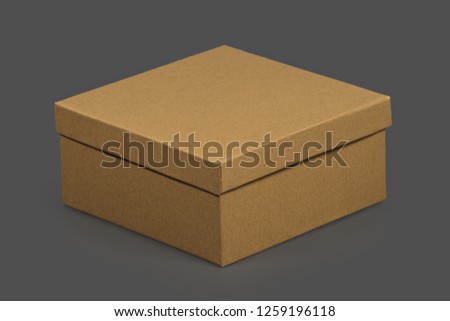 Blank black business card on gray table. Little gift box brown color with golden ribbon. Place for signature. Copy space. Corporate gift concept. Happy birthday concept.