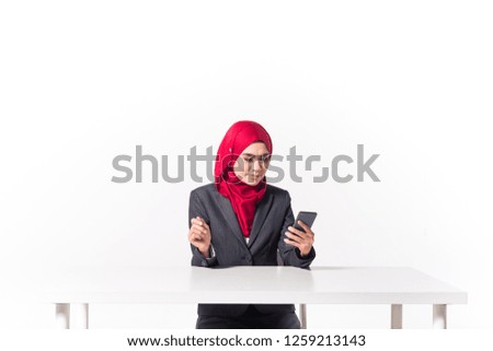 Muslim Woman Looking at Smartphone. Isolated on white background.
