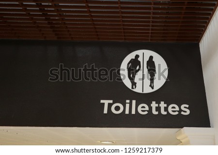 Restroom Toilet sign on a shop mail background