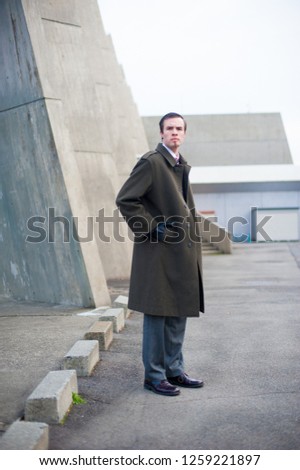 Caucasian male model poses for pictures on the street