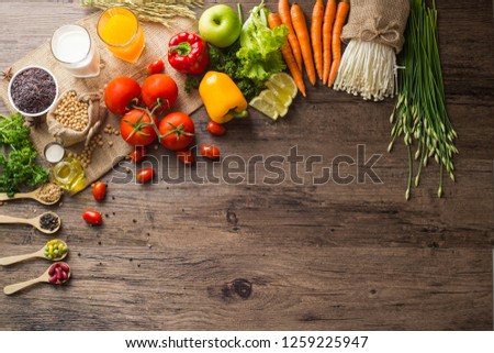 A Low key picture of Healthy food background ,fruits and vegetables on old wooden table.