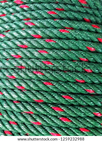 Close up of coiled green ropes on the deck of a fishing boat
