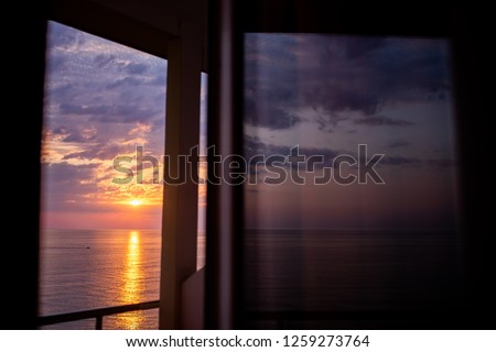 Beautiful sunset above the sea or the ocean, tropical resort, vacation. . View from the hotel window