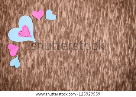 card concept with paper hearts and copyspace on textured brown paper