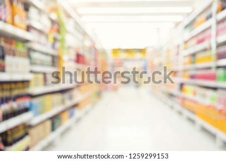 Supermarket or retail store blur background. That is a self-service shop offer grocery and variety of food, beverage and household product on shelf or rack. For product display, shopping background. Royalty-Free Stock Photo #1259299153