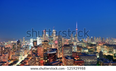 Toronto at dusk with city light and urban skyline with skyscrapers