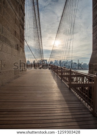 Walking The Brooklyn Bridge During the Early Morning with Cloudy Skies