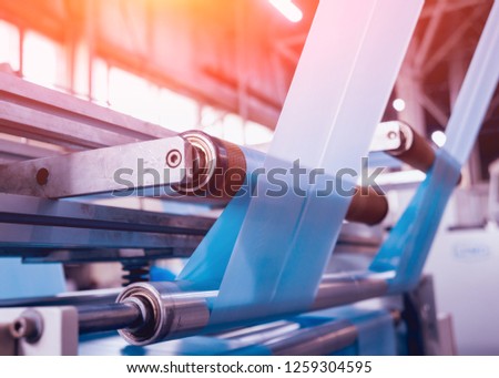 Modern automated production line in factory. Plastic bag manufacturing process. Background Royalty-Free Stock Photo #1259304595