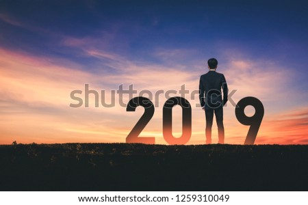 New year 2019 concept Silhouette young success business man with sky background at sunset
