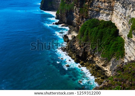 Bali seascape with huge waves and beautiful rocks. Sea beach nature, outdoor Indonesia. Island landscape. Summer holidays at ocean beach. Travel vacation in Indonesia beach.