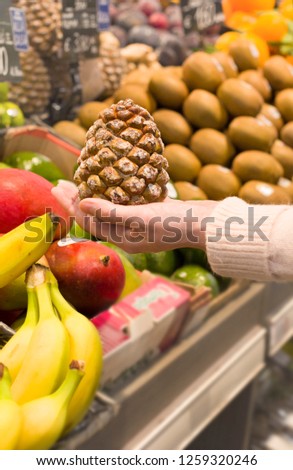 Female hand choosing fruits in the store