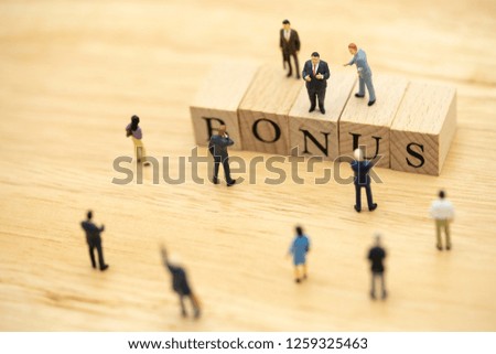 Miniature people Businessmen waiting for earnings Profits of the business To pay a bonus. using as background business concept and finance concept with copy space  for your text or  design.