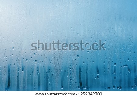 Condensation on the clear glass window. Water drops. Rain. Abstract background texture Royalty-Free Stock Photo #1259349709