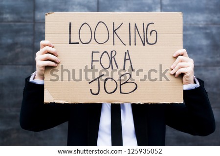 Young business woman holding sign Looking for a job Royalty-Free Stock Photo #125935052