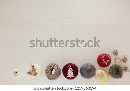 Christmas white wooden background with festive images decorations and gift boxes.
