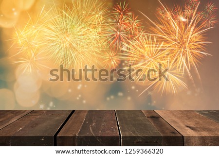 Firework display blowing up in the sky  over wooden floor with smoky bokeh ,copy space .
Celebration festival.