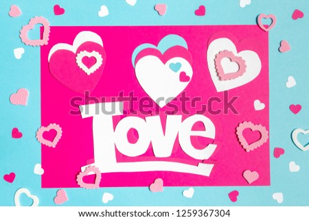 Valentine s Day greeting card. 14th of february. Happy Valentines Day Lettering with cut paper hearts on blue pink background with text  love