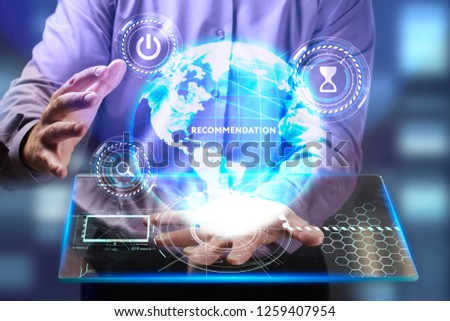 The concept of business, technology, the Internet and the network. A young entrepreneur working on a virtual screen of the future and sees the inscription: Recommendation
