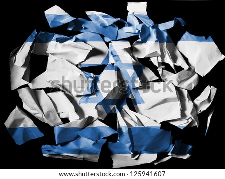 Israel. Israeli flag  painted on pieces of torn paper on black background