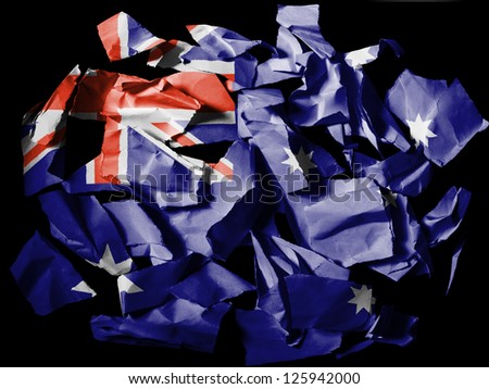 Australia.  Australian flag  painted on pieces of torn paper on black background
