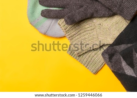 flat lay of winter warm clothes supplies on color background