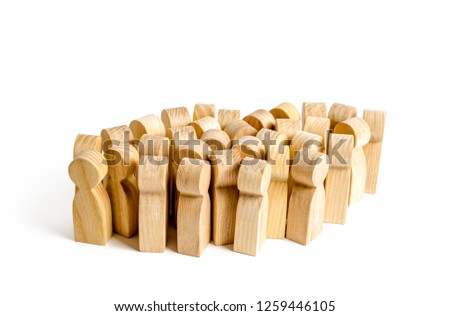 A large group of wooden figures of people. Society, community. social activity. Society, social group. Herd instinct, management of people. Human resources, workers stand together. crowd management