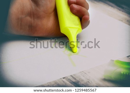 little girl draws with colored felt-tip pens. White background. have toning. close-up