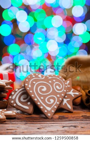 Gingerbread Christmas cookies on lighting background and wooden table