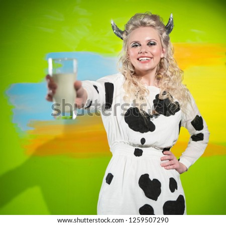 a beautiful girl with a smile on her face and in a cow costume h