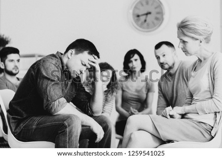 Black and white photo of man with mental disorder during therapy with psychiatrist