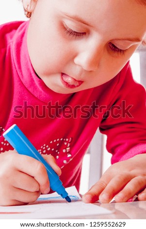 Great artist. Close up portrait of child girl draws felt-tip pens. Art, creative, talent, education,  happy childhood concept.