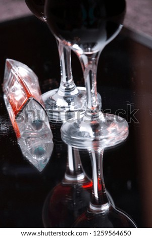 two glasses with red wine and perfume