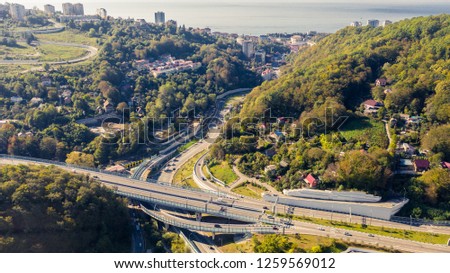 Aerial photography with quadrocopter. Sochi bypass road, traffic cars, traffic jams, urban environment. The road to the sea. A trip by car to travel.