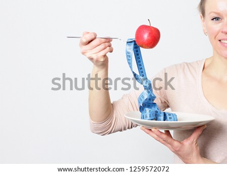 apple with tape measure representing dieting slimming and weight loss stock photo