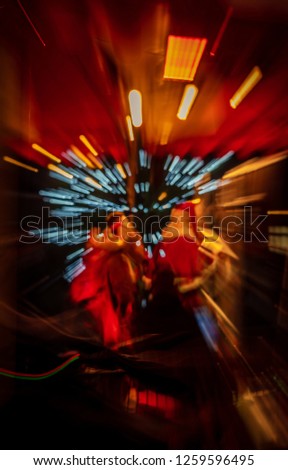 Special effect motion blur with bokeh lighting zooming into  Santa Claus in his red costume