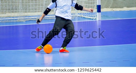 Football Futsal Ball and man Team. Indoor Soccer Sports Hall. goalkeeper with a ball