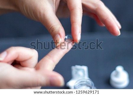 Orthokeratology lens in woman's hands Royalty-Free Stock Photo #1259629171