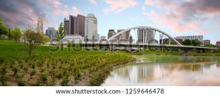 Unique perspective of the Columbus skyline with fancy bridge over the river