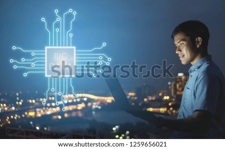 Businessman stand on roof top using laptop with Big data hologram on his hand and element of this image furnished,smart city and network connect concept