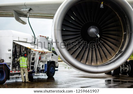 Aircraft refueling by high pressure fuel supply truck.Passenger jet airplane refuel from supply truck, airport service, refuel,Aircraft Refueling Hose. Royalty-Free Stock Photo #1259661907