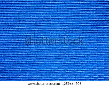Close-up of the blue textile texture, background and wallpaper. The texture of blue fabric textile upholstery of furniture. High-quality macro photography.