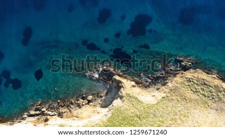 Aerial bird's eye view photo taken by drone of tropical seascape and rocky beach with turquoise clear waters