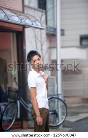 Asian male model poses for pictures on the street