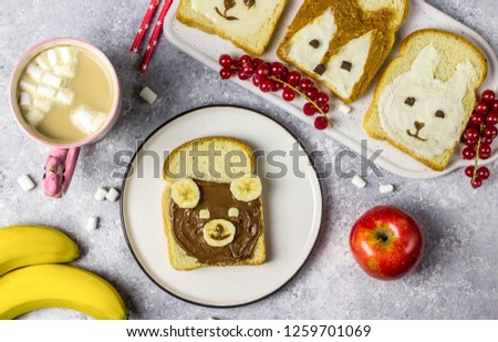 Funny animal sandwich for kids shaped cute bear, panda, fox, rabbit with peanut butter, honey, chocolate paste and banana. Top vew
